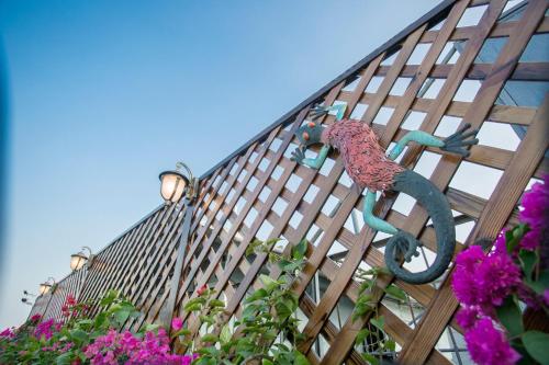 a wooden fence with flowers in front of a building at Mumian inn in Chaozhou