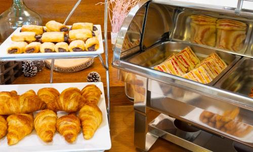 two pictures of pastries and croissants in a bakery at Hotel Spa Attica21 Vilalba in Villalba