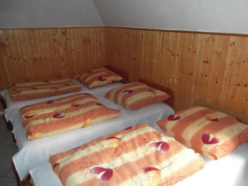 a group of four beds in a room at Dworek w Zieleni in Warsaw
