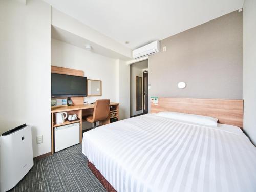 Giường trong phòng chung tại Super Hotel Mihara Ekimae