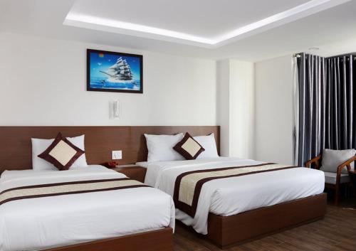 pokój hotelowy z 2 łóżkami i oknem w obiekcie DORADO HOTEL w mieście Nha Trang