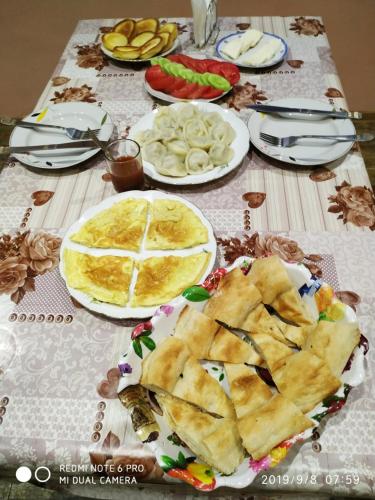 a table with plates of food on top of it at Guest House Besarioni in Borjomi
