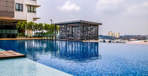 a large swimming pool on top of a building at 2 Bedroom 2 BATHROOM NEAR SUMWAY PYRAMID in Subang Jaya