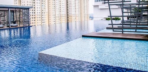 a swimming pool in a building with tall buildings at 2 Bedroom 2 BATHROOM NEAR SUMWAY PYRAMID in Subang Jaya