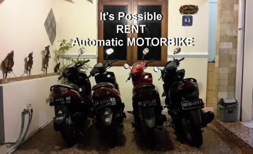 a group of motorcycles parked in a garage at The Homey Rooms and Tours in Yogyakarta