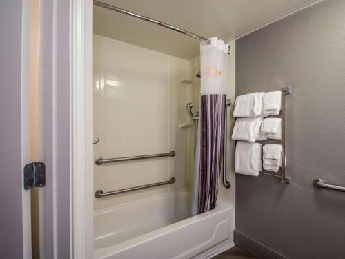 a bathroom with a tub and a shower with towels at La Quinta by Wyndham Orem University Pwy Provo in Orem