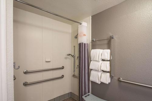 a bathroom with a shower stall and towels at La Quinta by Wyndham Orem University Pwy Provo in Orem