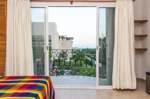 a bedroom with a large sliding glass door to a balcony at Hotel Sol Playa in Playa del Carmen