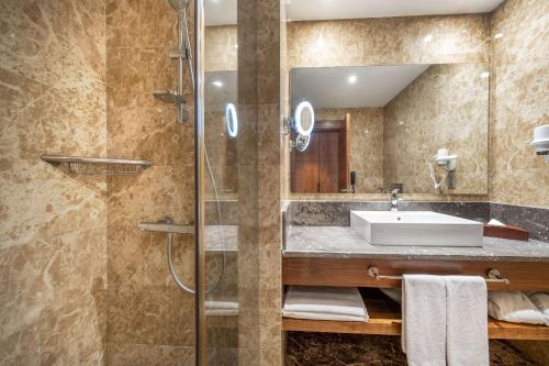 a bathroom with a sink and a shower at Clarion Hotel Istanbul Mahmutbey in Istanbul