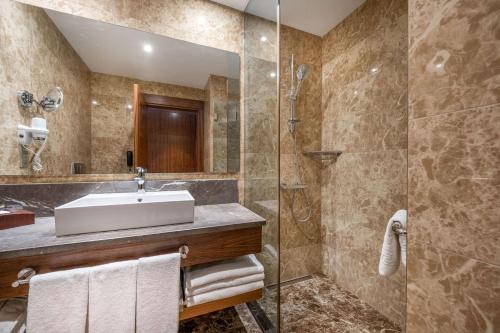 a bathroom with a sink and a shower at Clarion Hotel Istanbul Mahmutbey in Istanbul