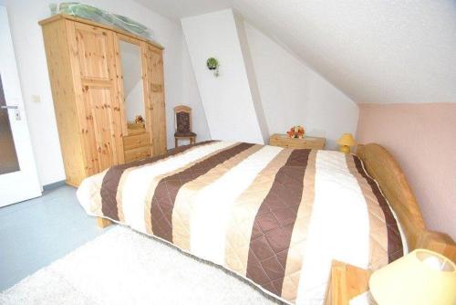 sypialnia z dużym łóżkiem na poddaszu w obiekcie Haus Rehblick FeWo-OG-3 w mieście Sankt Andreasberg