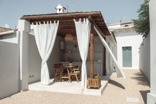 a gazebo with a table on a patio at Casa Clementa in Pula