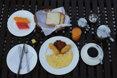 a table with plates of food and a cup of coffee at Shangrila Boutique Hotel in Kathmandu
