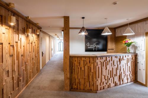 a hallway with wood paneled walls and a reception counter at Фетрбуш in Nadvirna