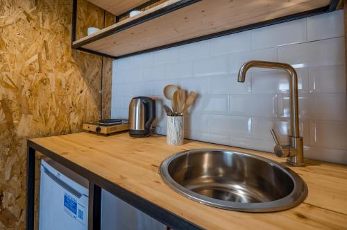 a kitchen counter with a sink in a kitchen at Kazbegi 5054 in Stepantsminda
