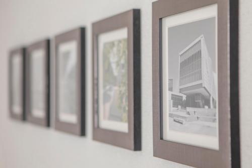 a row of framed pictures hanging on a wall at Art Hotel Osaka Bay Tower in Osaka