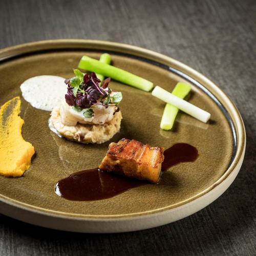 a plate of food with meat and vegetables on it at Hotel Astoria in Samnaun