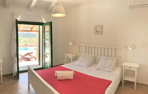 a bedroom with a bed with a red blanket on it at Villa Dule in Pakoštane