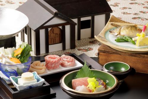 a table with plates of food and a toy house at Hotel Shion in Morioka