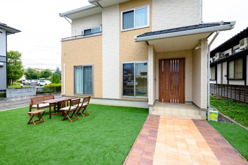 a patio with a table and chairs in front of a house at ID-STAY Kawaguchiko Ⅱ in Fujikawaguchiko