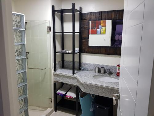 a bathroom with a sink and a shower at Cucun's place in Manila