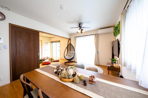 a living room with a wooden table and a living room at ID-STAY Kawaguchiko Ⅱ in Fujikawaguchiko