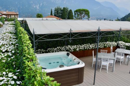 a jacuzzi tub on a deck in a garden at Villa Vitali - Bellagio in Bellagio