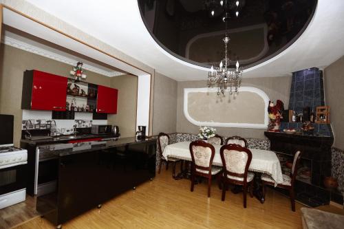 a kitchen and dining room with a table and chairs at Lela Apartments in Tbilisi City