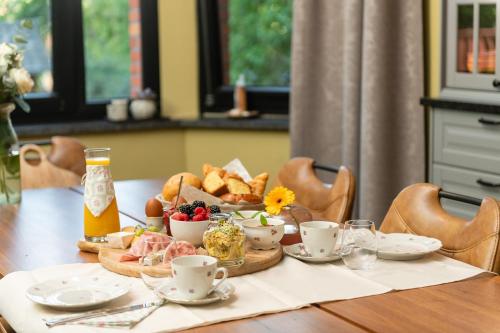 a table with a tray of bread and a plate of food at B&B Parkhuys in Antwerp