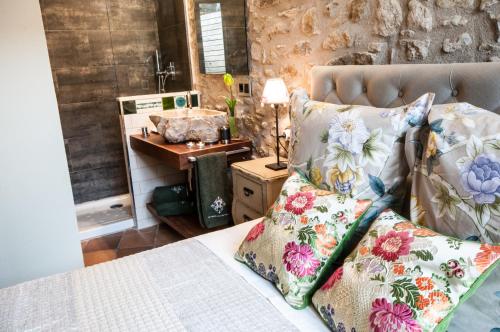 a bedroom with a bed with two pillows on it at El Racó de Madremanya - Adults only in Madremanya