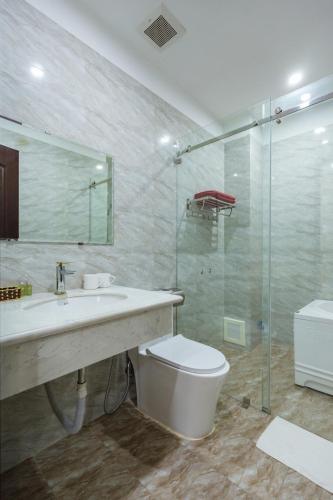 a bathroom with a sink and a toilet and a shower at The Peninsula Haiphong in Hai Phong