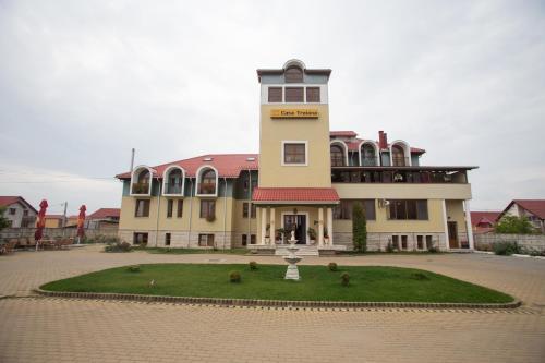 a large building with a clock tower on top of a grass circle at Casa Traiana in Alba Iulia