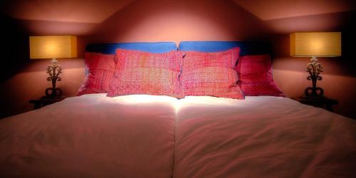 a bedroom with a bed with two lamps on it at Menin Gate House in Ypres