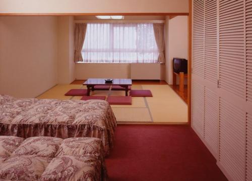 Postel nebo postele na pokoji v ubytování Hotel Chalet Yuzawa Ginsui