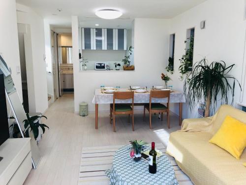 a living room with a table and a couch at Takara House in Tokyo