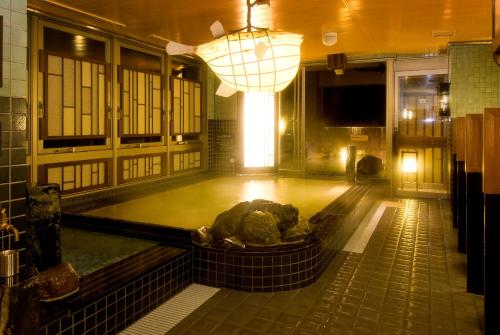 a pool of water in a room with a light at Dormy Inn Premium Shimonoseki in Shimonoseki