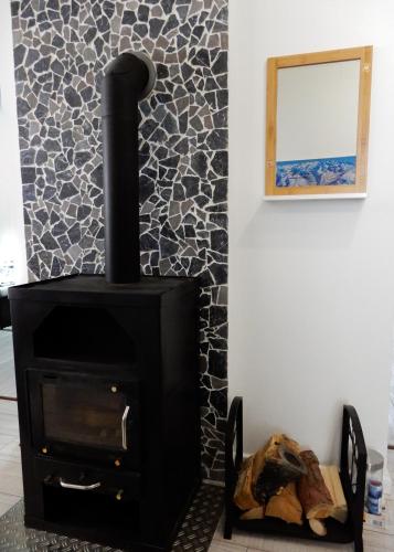 a black wood stove in a room with a mirror at Apartment for your Holiday in Ramingstein