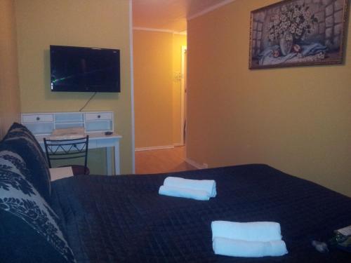 a bedroom with a bed with two towels on it at Barents Hotell in Kirkenes