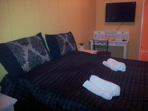 a bedroom with a bed with two towels on it at Barents Hotell in Kirkenes