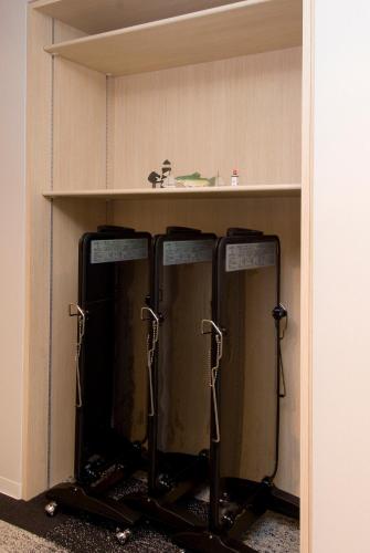 two water tanks in a shelf in a room at Dormy Inn Premium Shimonoseki in Shimonoseki