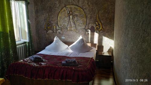 a bedroom with a bed with towels on it at Mubina Khiva B&B in Khiva