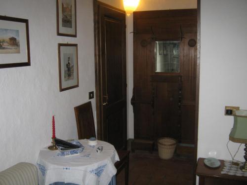 a room with a table and a door with a candle at Agriturismo Santa Maria in Torrita di Siena