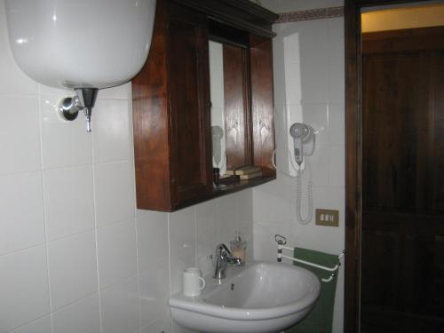 a bathroom with a sink and a phone on the wall at Agriturismo Santa Maria in Torrita di Siena