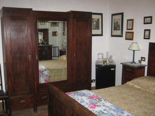 a bedroom with two beds and a large mirror at Agriturismo Santa Maria in Torrita di Siena