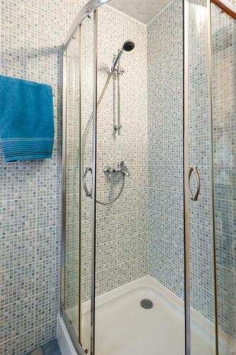 a shower with a glass door in a bathroom at Apartamenty Pod Gondolą in Szczyrk