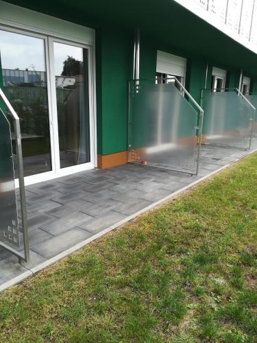 a building with two glass doors and a green wall at Jura Hotel in Nürnberg