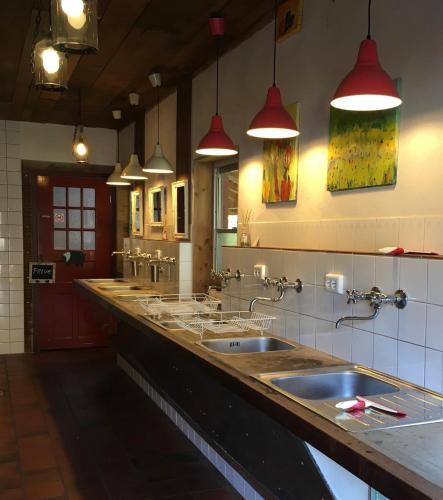 a large bathroom with two sinks and two mirrors at 't Keetje in Groesbeek