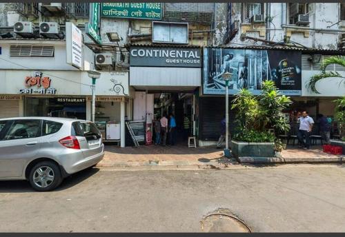 a silver car parked in front of a building at Continental Guest House in Kolkata