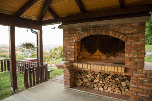 a brick oven with a pile of fire wood at Apartmani Petra i Tea in Krapina