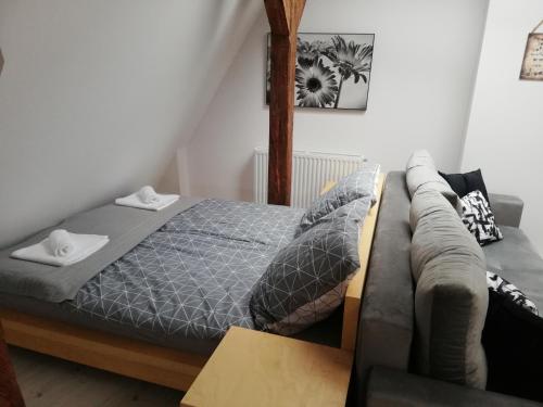 a bedroom with a bed and a couch at Apartament Tower in Bydgoszcz